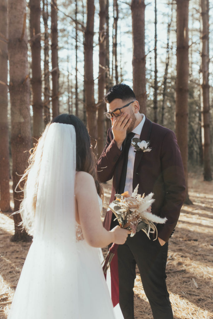 Photo of an emotional first look between bride and groom.