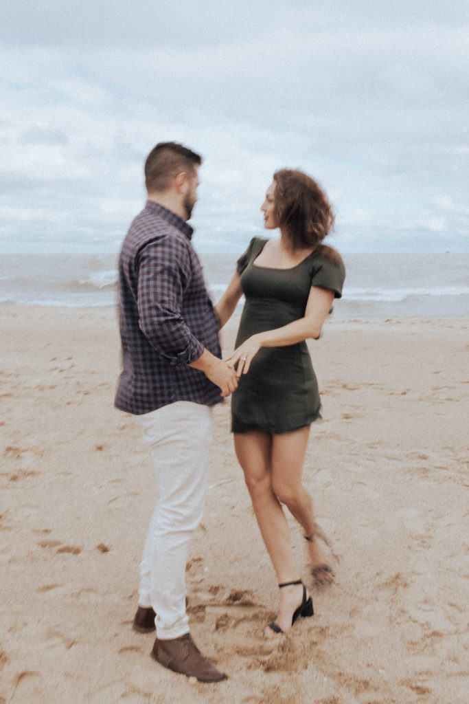 Photo of a couple dancing on the beach.