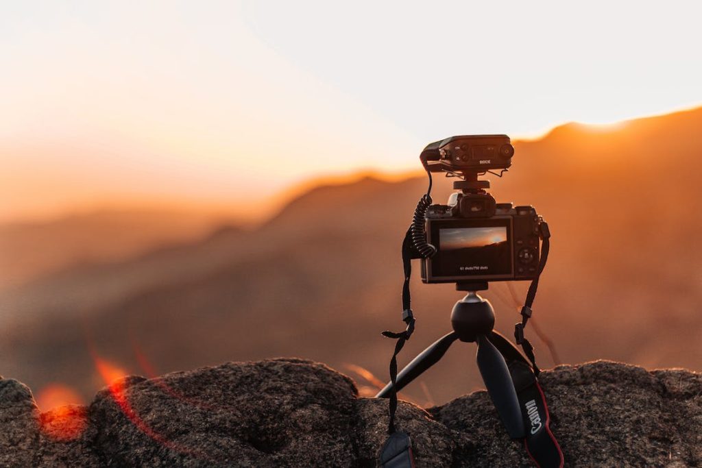 A camera on a cliff during sunset.