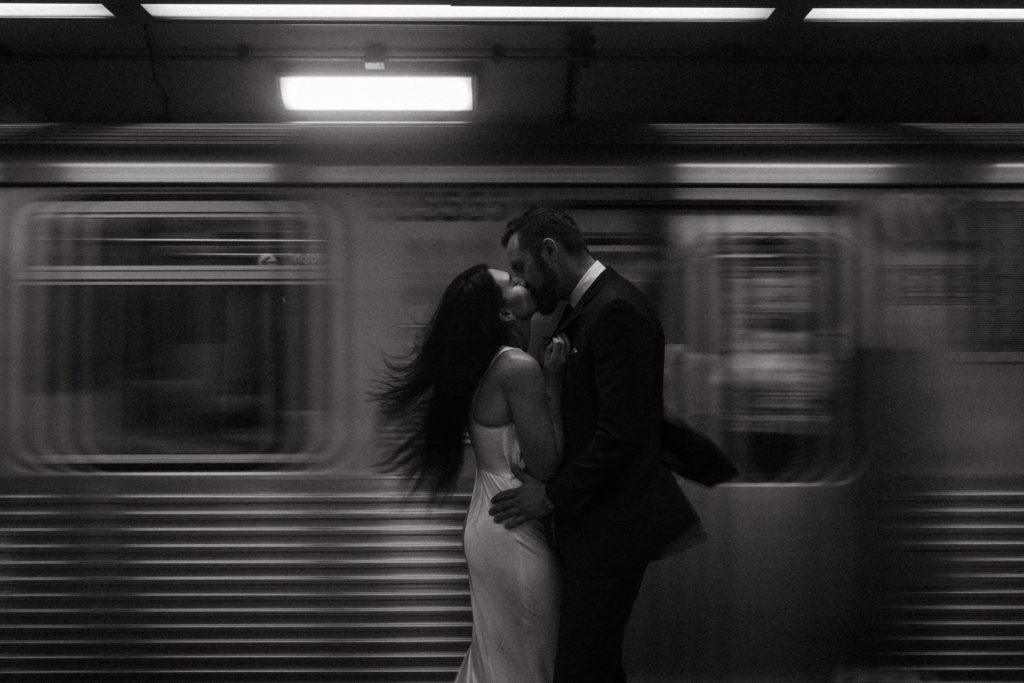 A couple kissing in the subway.
