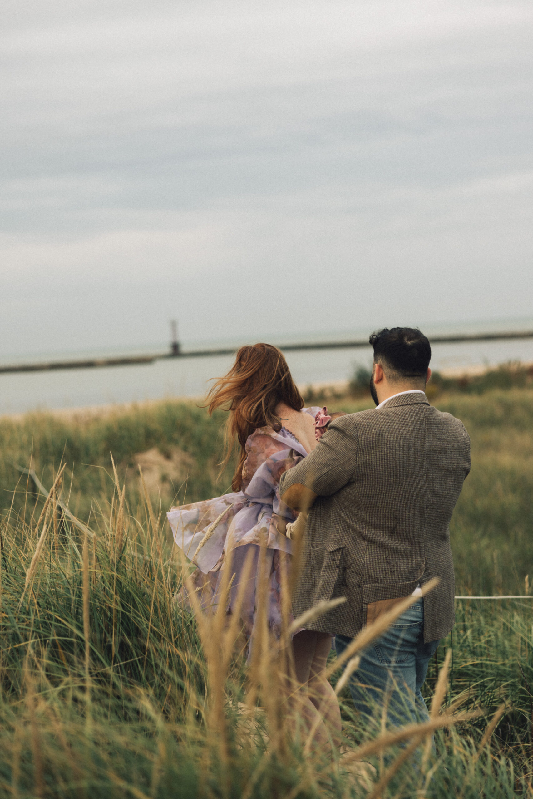 Kenice & Joey welcomed their daughter Naomi in the summer and we took to Lake Michigan on a beautiful, breezy fall afternoon. At this whimsical Chicago family beach session, we documented organic, sweet moments as golden hour arrived