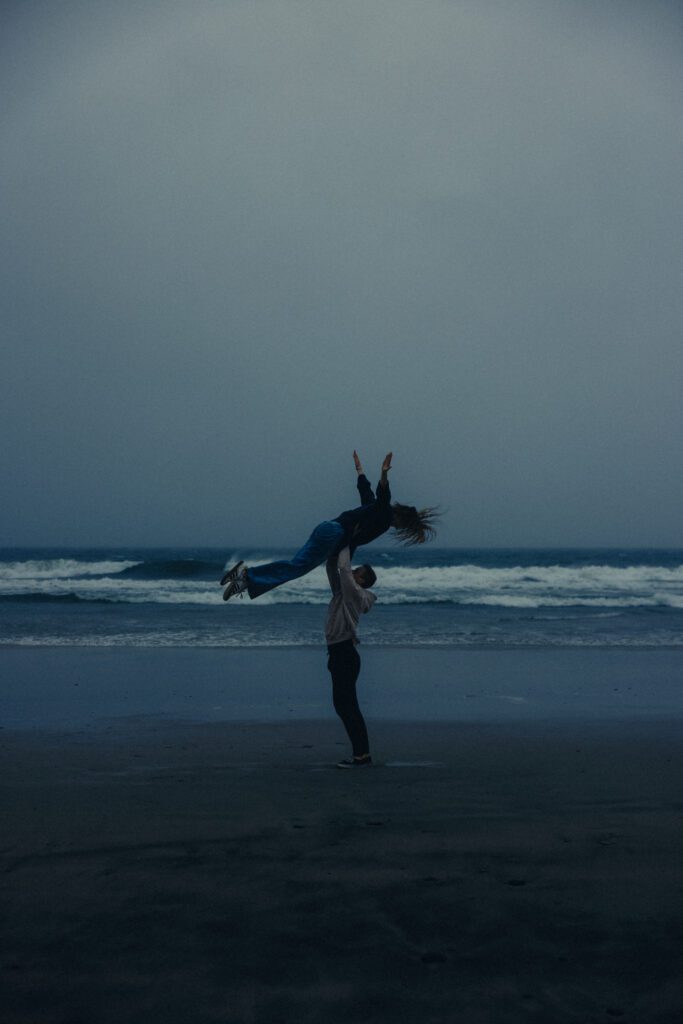 dancing on the beach in the rain