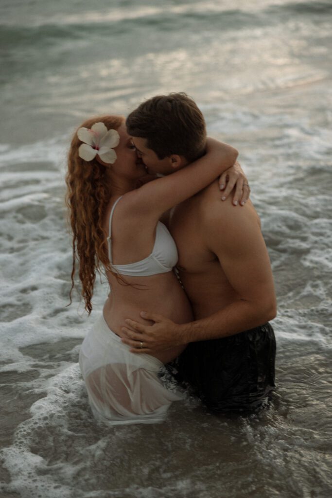 couple embracing in a kiss at torrey pines beach
