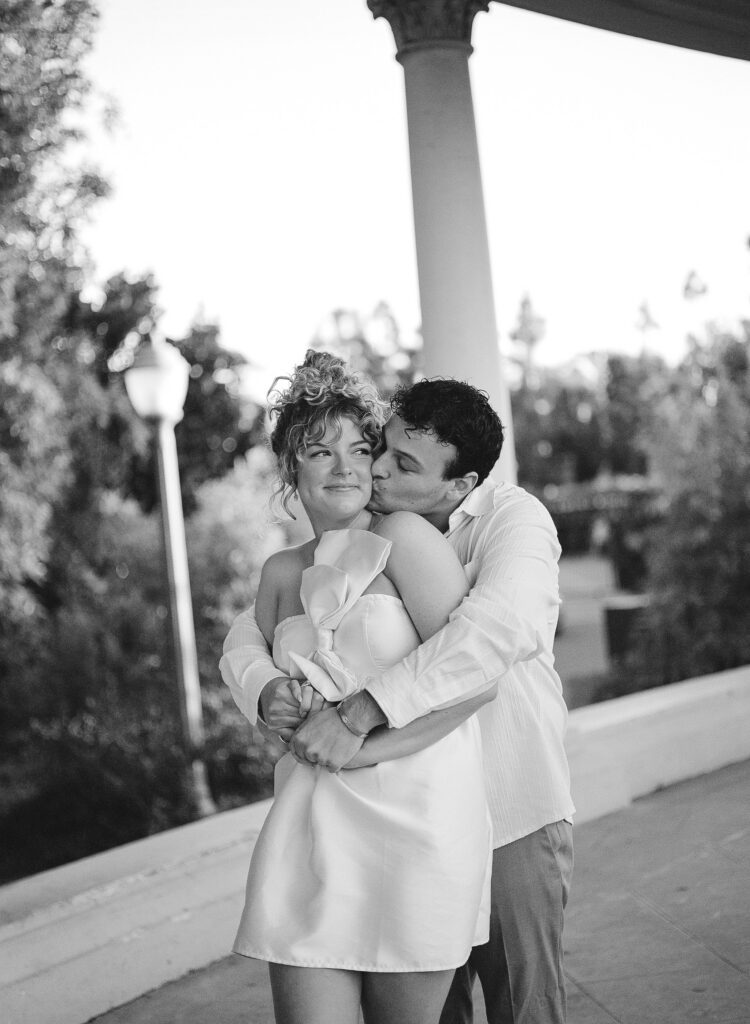 couples photos surrounded by beautiful architecture at balboa park in black and white