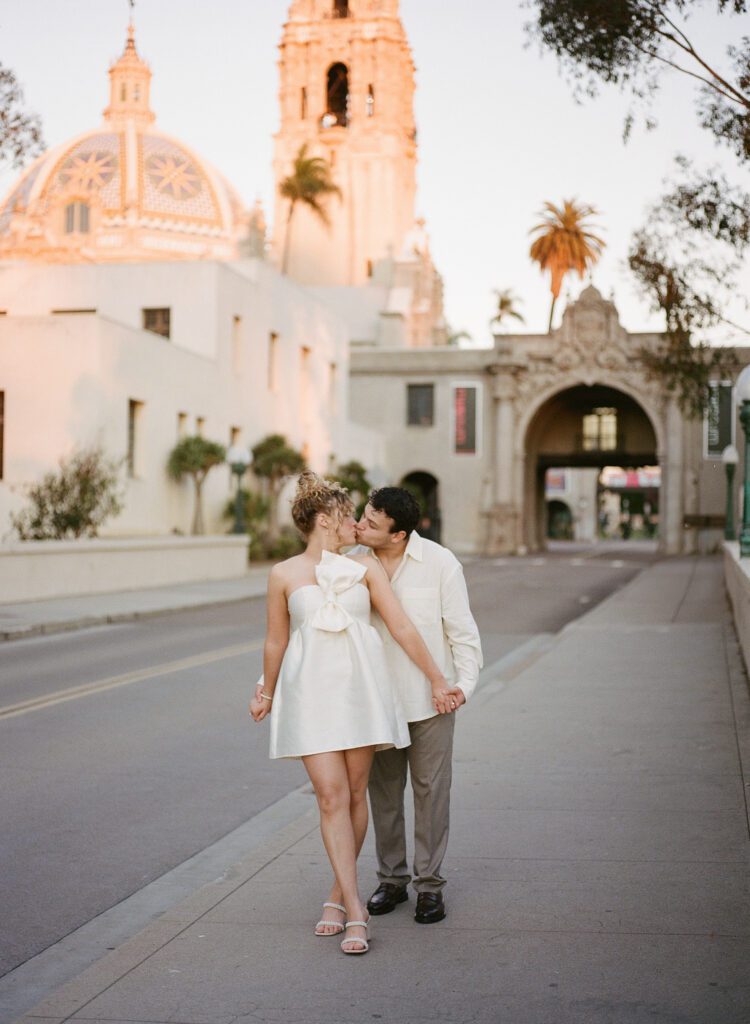 couples photos surrounded by beautiful architecture at balboa park on film