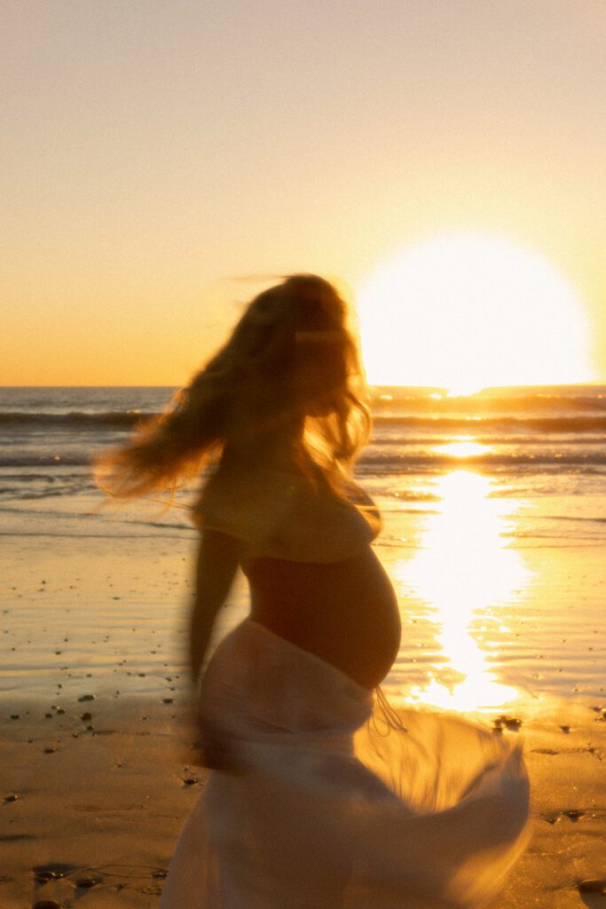 twirling beach maternity photos