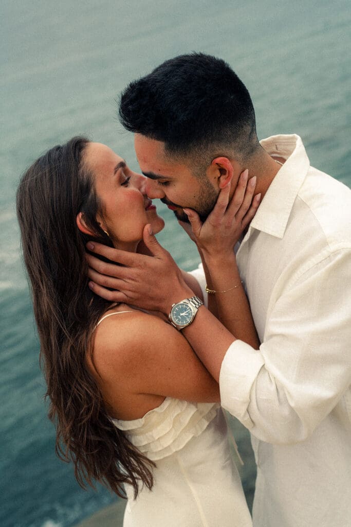 couple kissing during their coastal engagement photos