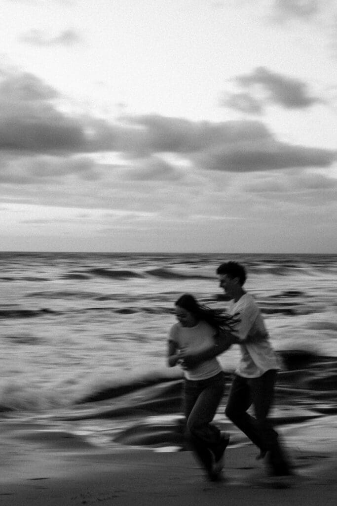 cinematic couples portraits on the beach at golden hour in black and white